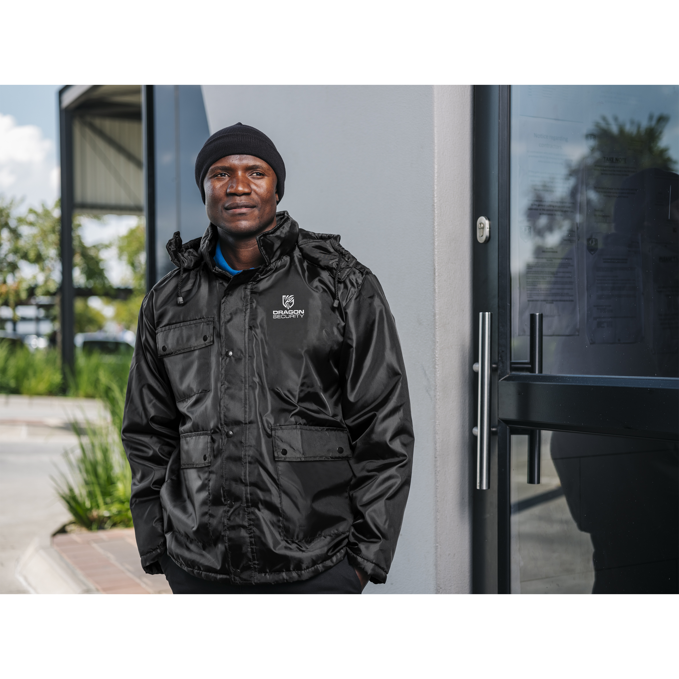 Branded winter workwear worn by a crew member on an early-morning industrial site